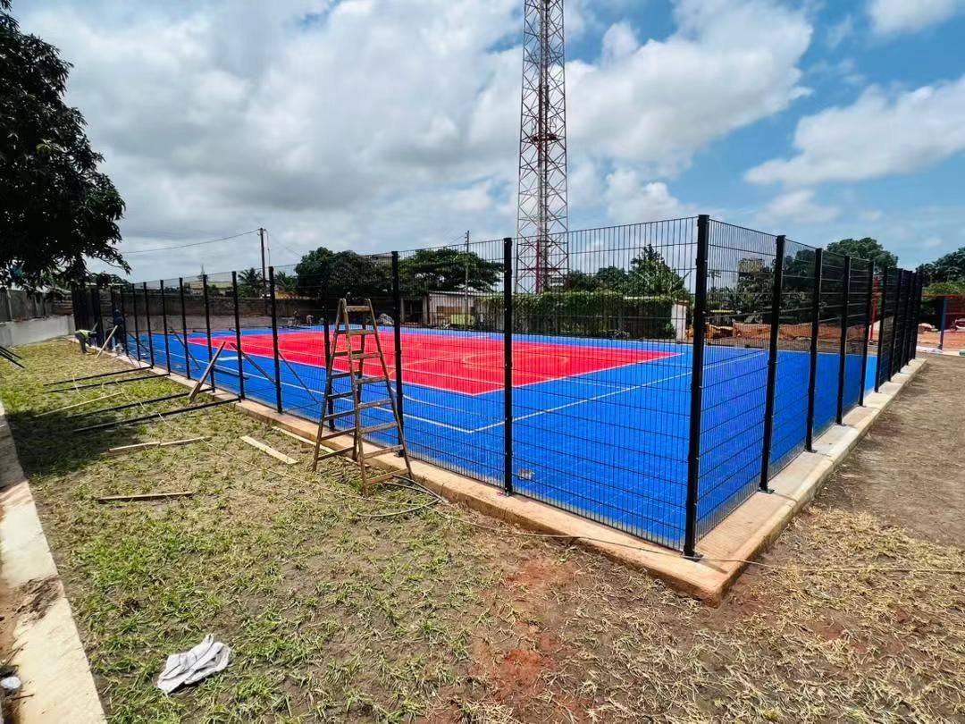 Completed welded wire mesh fence around a sports court in Ghana
