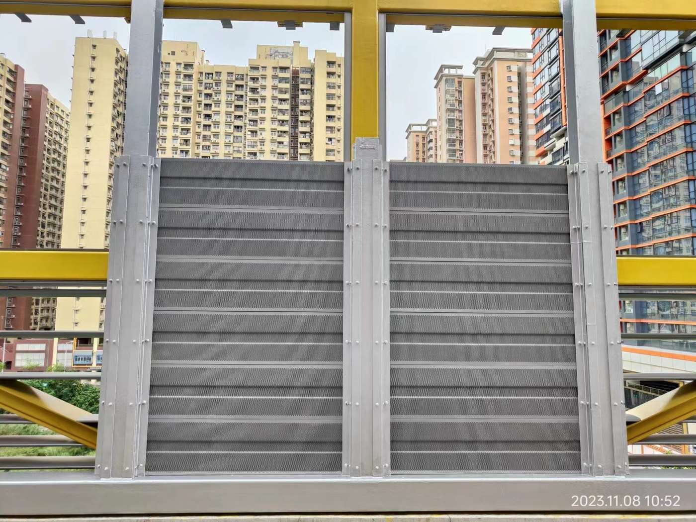 Close-up of metal noise barrier panels and their fixing frame