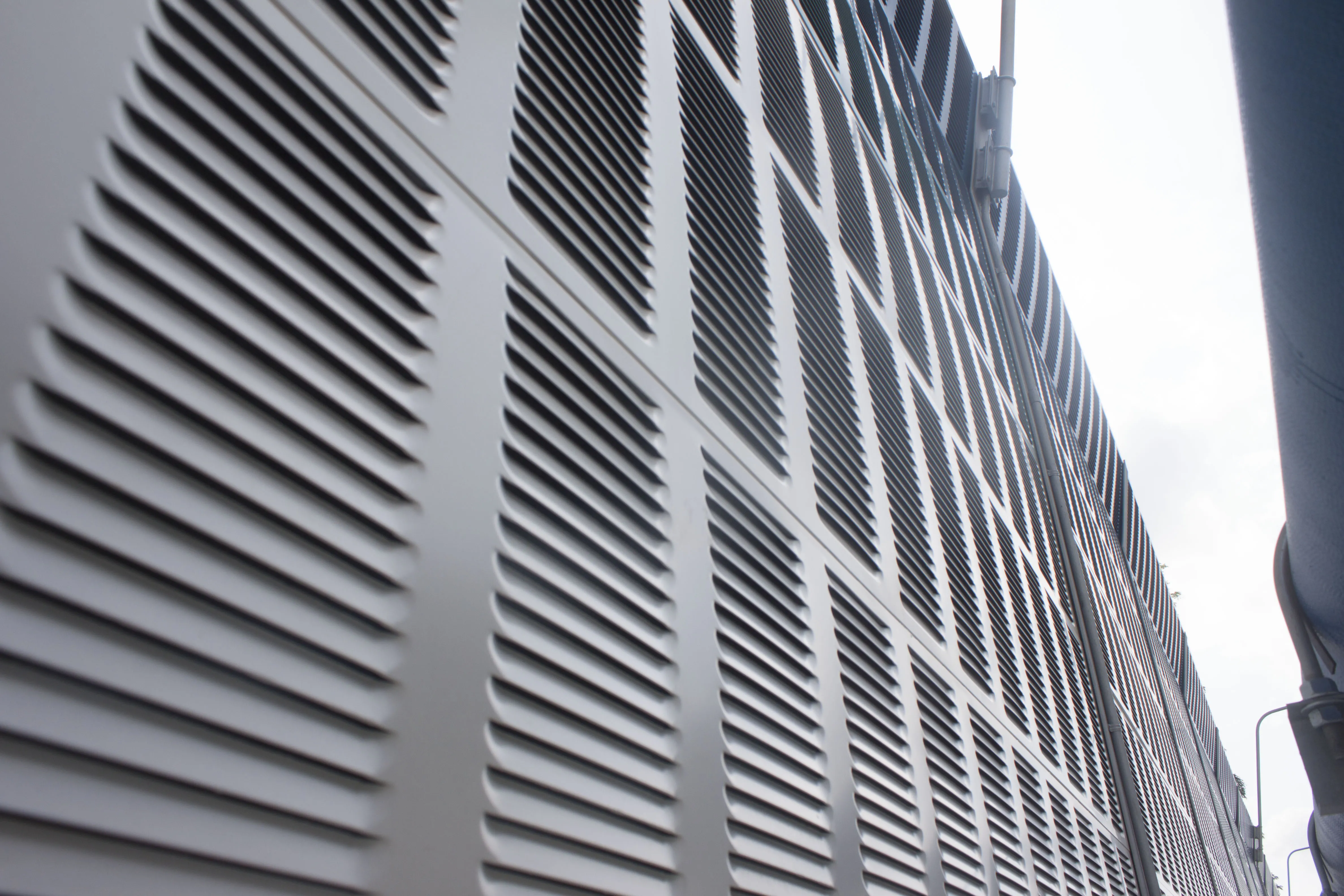 Close-up view of highway noise barrier panel showing material texture and mounting details