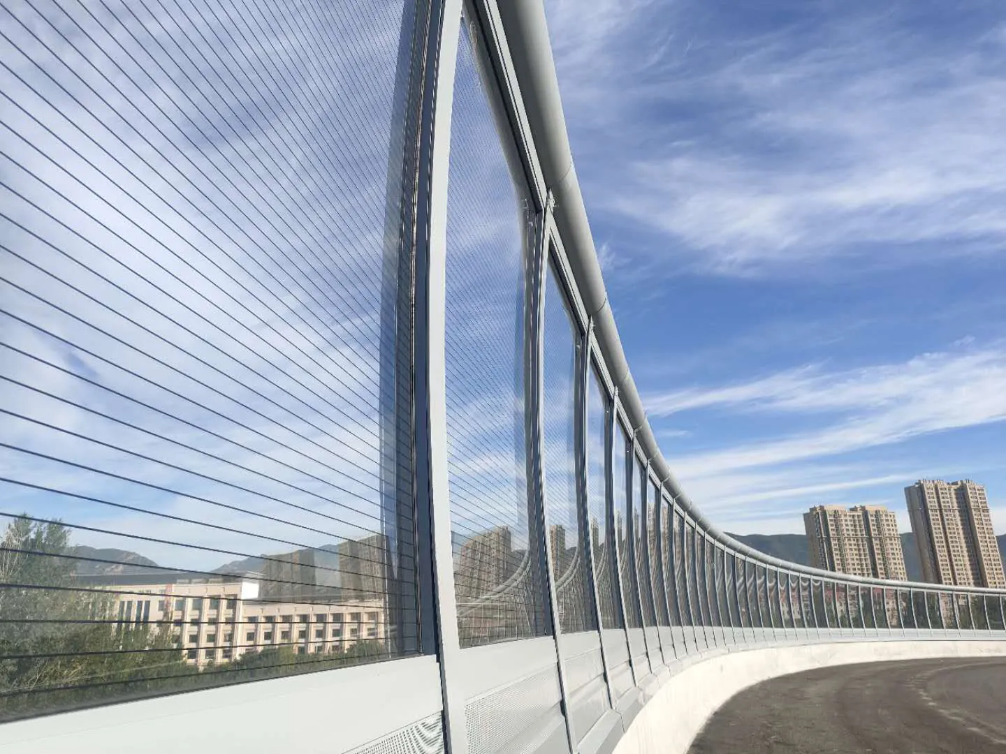 Close-up view of highway noise barrier panel showing material texture and mounting details