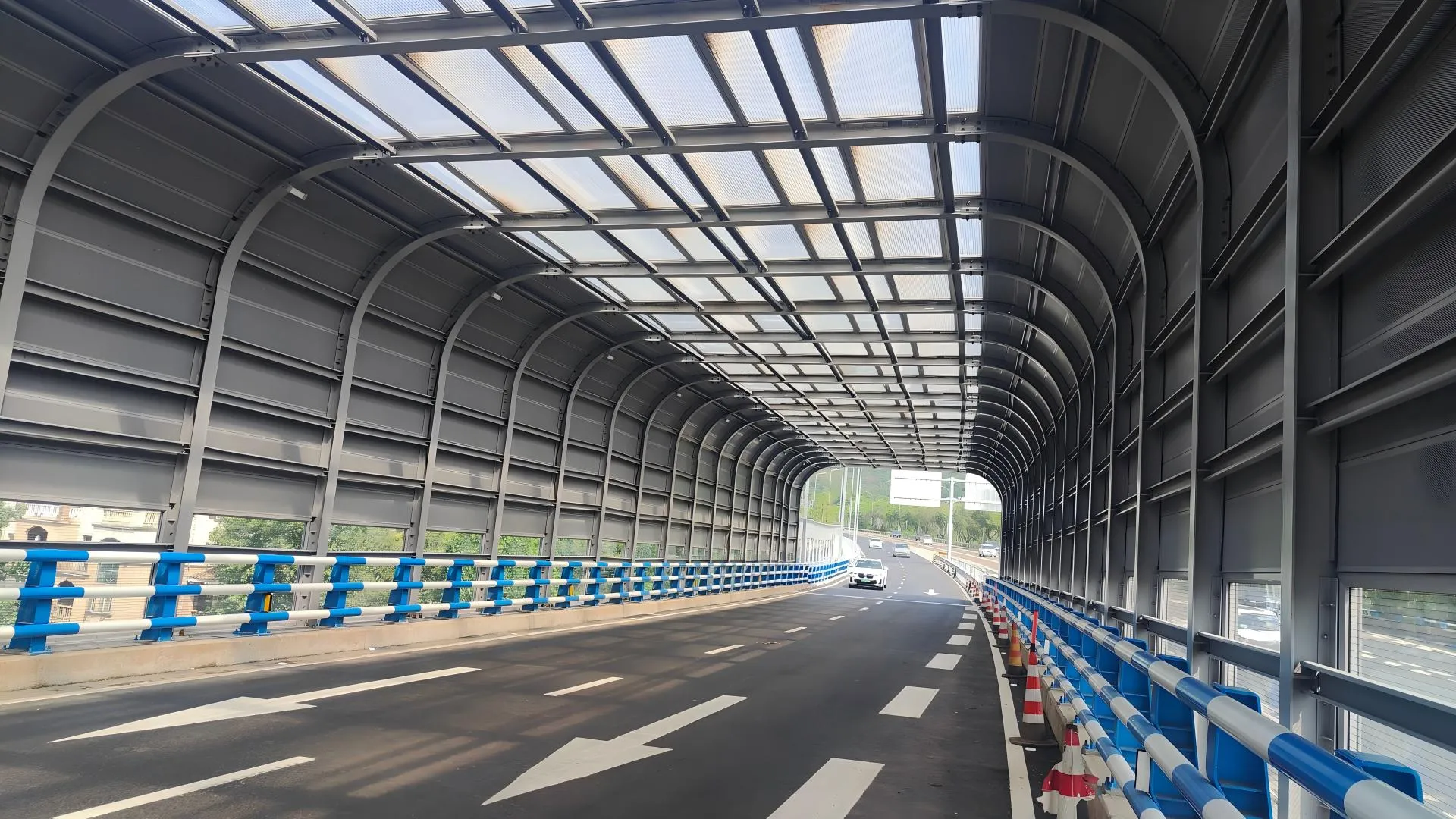 Close-up view of highway noise barrier panel showing material texture and mounting details
