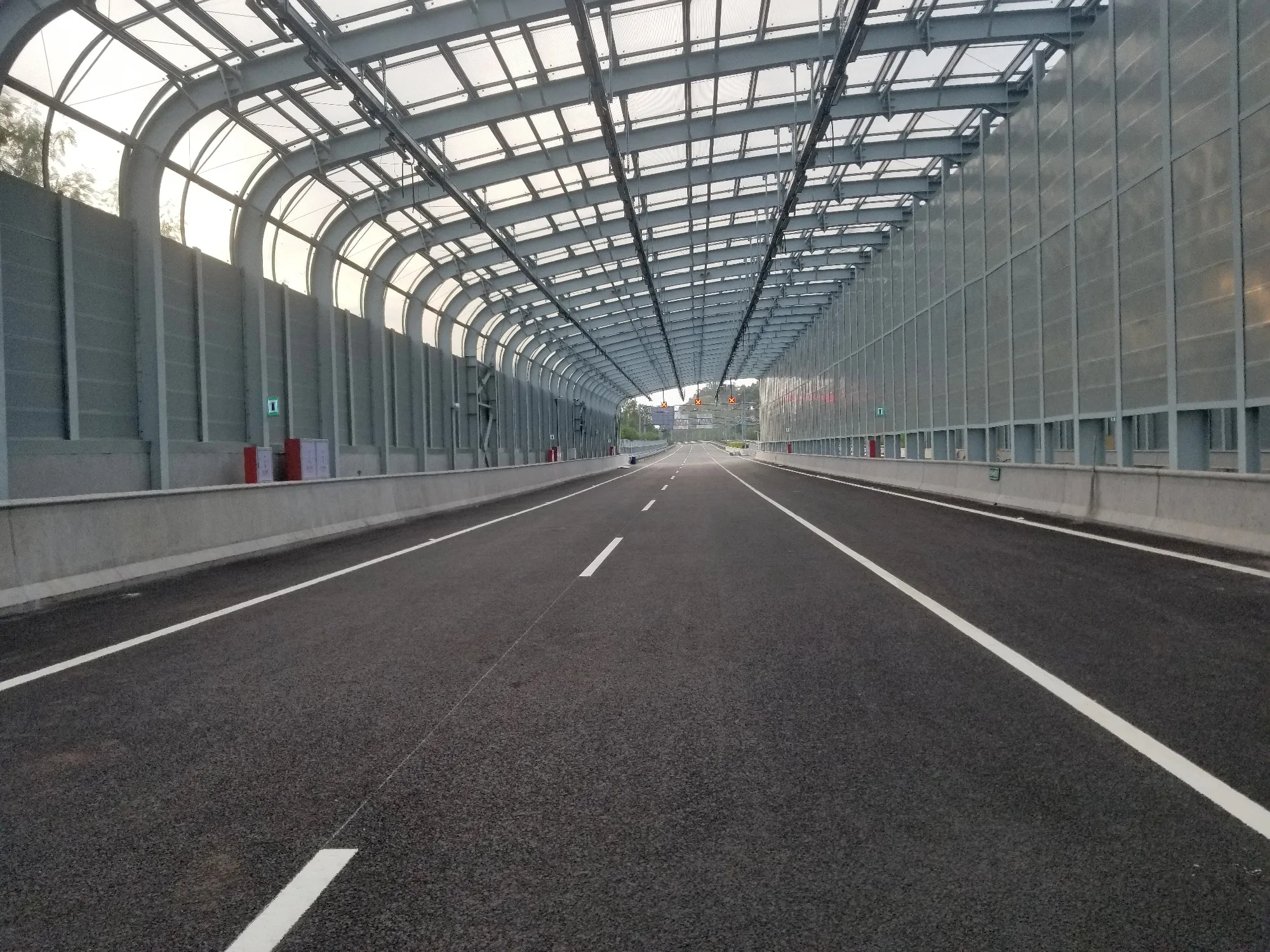 Fully enclosed noise barrier installed along a busy motorway
