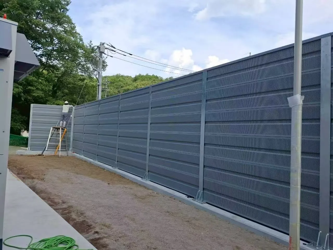 Close-up view of civil noise barrier panel showing material texture and mounting details