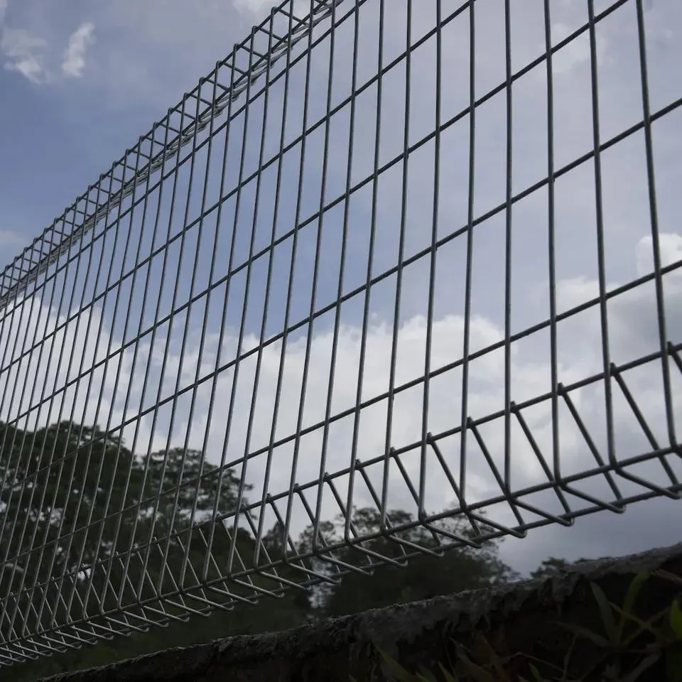 Green BRC roll top fencing installed for a school playground security.