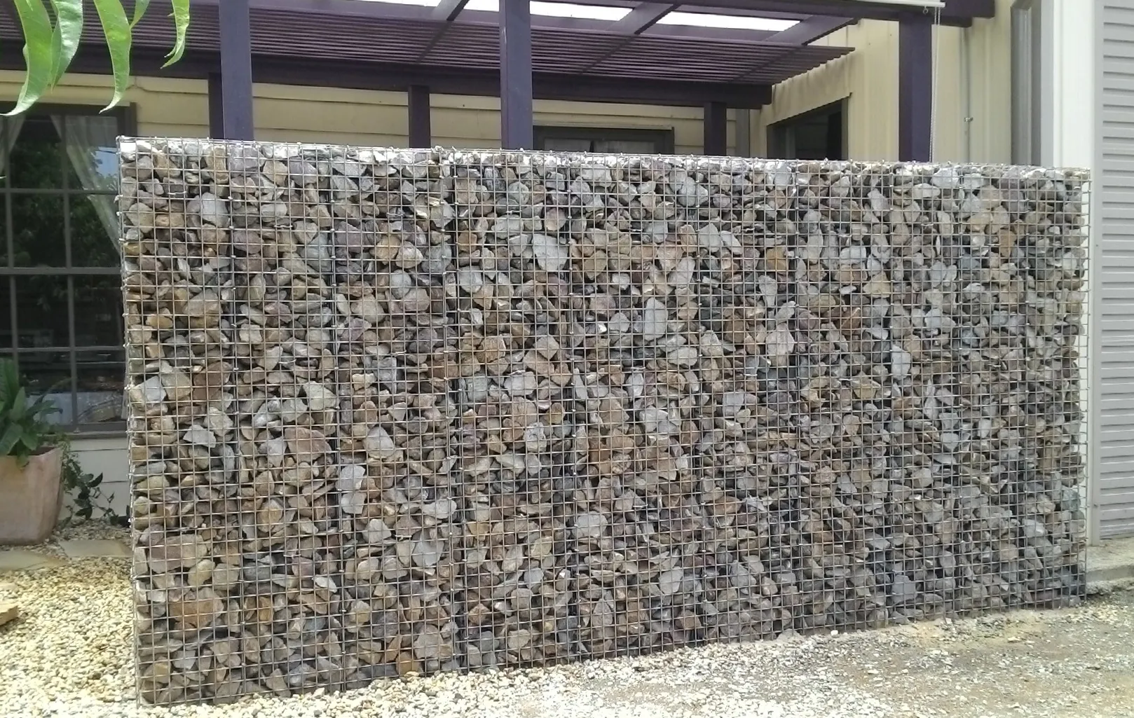 Welded gabion retaining wall for slope stabilization project