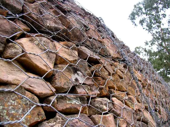Woven gabion retaining wall for slope stabilization project