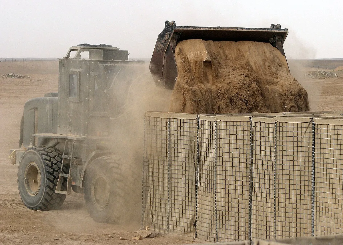 Deployable barrier system with welded wire mesh and geotextile lining structure